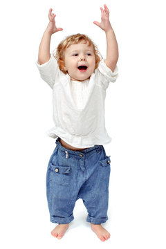 Young baby standing indoors applauding and smiling