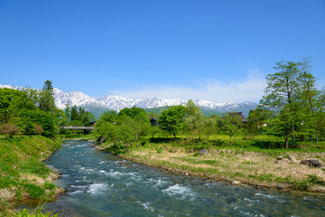 Naklejka na ściany i meble Shirouma mountains and Himekawa river at Ooide park in Hakuba, Nagano, Japan