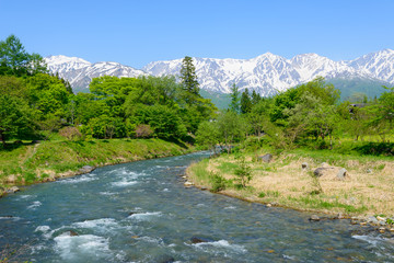 Naklejka na ściany i meble Shirouma mountains and Himekawa river at Ooide park in Hakuba, Nagano, Japan