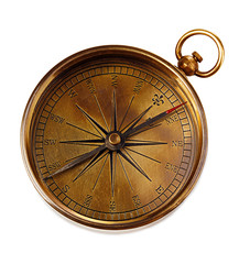 Old vintage brass compass isolated on a white background.