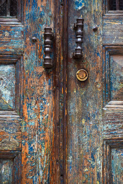 Retro door handles on an old wooden door. Door belongs to a Turkish House.