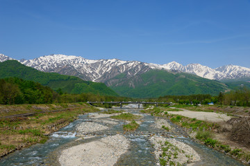 Fototapeta na wymiar Shirouma mountains and Matsukawa river in Hakuba, Nagano, Japan