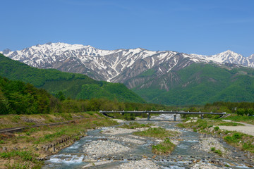 Fototapeta na wymiar Shirouma mountains and Matsukawa river in Hakuba, Nagano, Japan