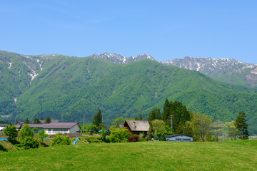 Fototapeta na wymiar Ushiro-tateyama mountains, a part of Northern Alps, and countryside