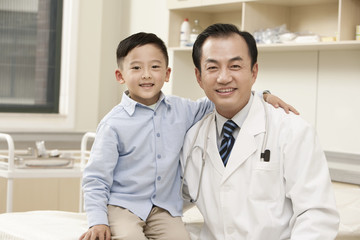 Doctor and Young Boy In Examination Room