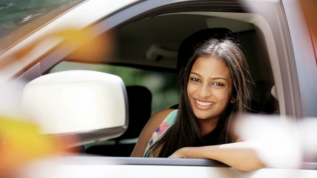 Portrait of young Indian American female taking driving lessons in vehicle