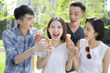 Happy young adults eating ice cream