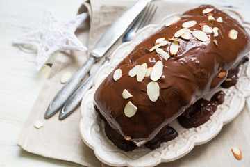 Homemade cupcake with chocolate icing and almonds