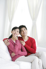 Young Chinese couple in living room