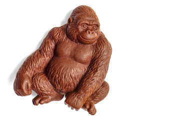 Chocolate gorilla monkey covered with water drops isolated on wh