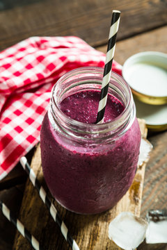 Smoothies in jar on a wooden table