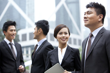 Cheerful businesswoman with her team in Hong Kong