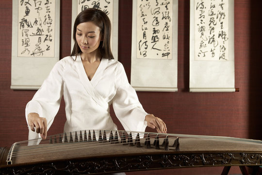 Young Woman Playing Traditional Chinese Instrument