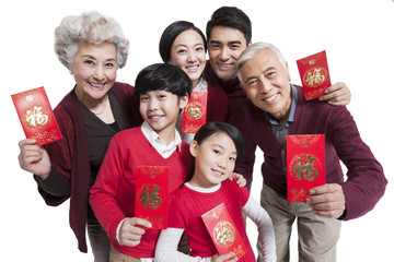 Happy family showing red pockets celebrating Chinese New Year