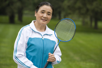 Senior Woman Holding Badminton Racket in a Park