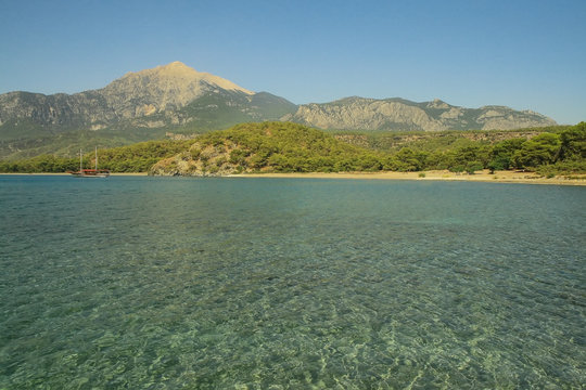 Clear sea with mountain in the background
