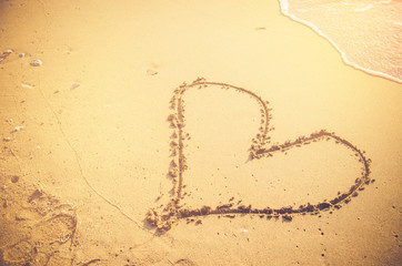 hand draw heart on sand beach valentine concept