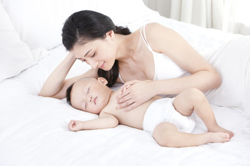 Obraz na płótnie Canvas Gentle mother with sleeping baby