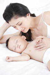 Obraz na płótnie Canvas Gentle mother with sleeping baby