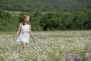 Fototapeta na wymiar Ginger girl on meadow