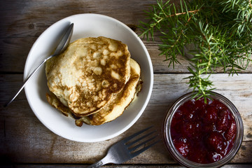 pancakes and strawberry jam on the rustic table