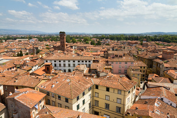 Fototapeta na wymiar Skyline of the city of Lucca, Italy. Seen from the Torre delle ore towards the Guinigi tower