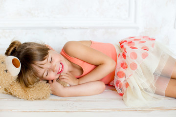 the little ballerina sleeps on a teddy bear