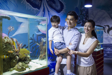 Young family in aquarium