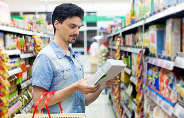man in a supermarket buying a box of cornflakes