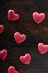 Obraz premium Three red heart on wooden background