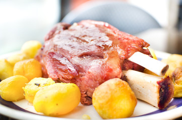 roasted pork shank with potatoes background closeup up  - trentino alto adige