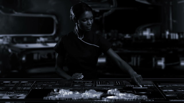 Caucasian USA female using table touchscreen technology in futuristic office