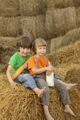 teenager on a haystack with bread and milk