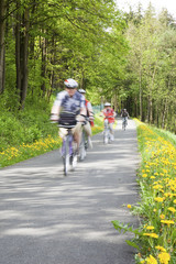 People cycling through countryside