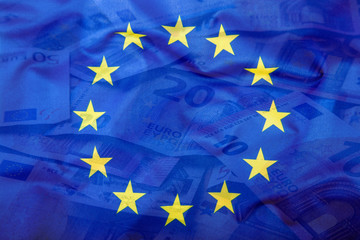 Euro flag. Euro money. Euro currency. Colorful waving european union flag on a euro money background.