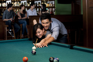 Couple Playing Pool Together