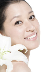 Beauty shot of a young woman with a Lily flower