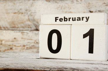 image of February First wooden vintage calendar on white background
