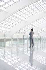 Fototapeta premium Businessman standing in empty hall