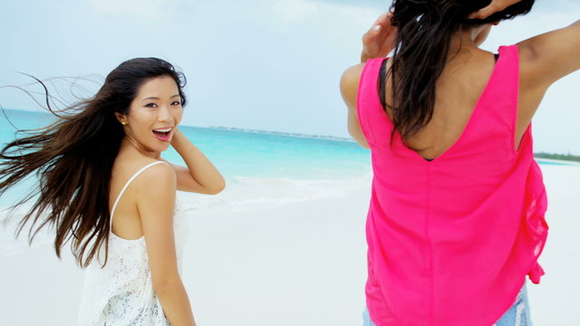 Portrait of African American Asian Chinese girls on beach 