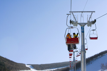 View of two people in a ski lift