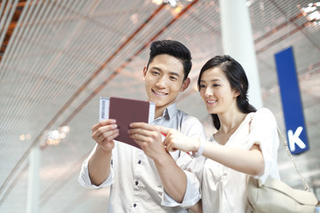 Young couple with tickets at the airport