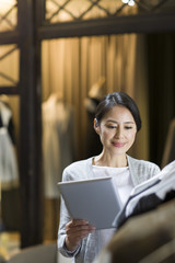 Clothing store owner with digital tablet