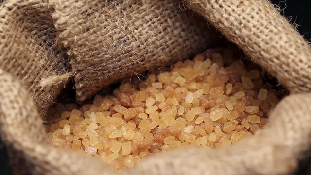 Brown sugar in gunny sack, rotating
