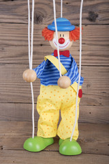 Clown puppet on old wooden table