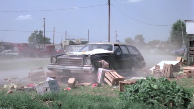 Station wagon crashing into fruit stand