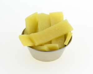 Bamboo shoots in a small cup on a white background
