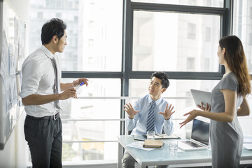 Young business people talking in meeting