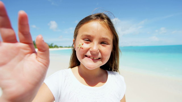 portrait smiling young female Caucasian child beach tropical ocean casual living