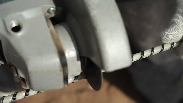 Worker Using A Grinding Machine To Cutting Fiberglass Reinforcement. Fiberglass Reinforcement. Composite Rebar.